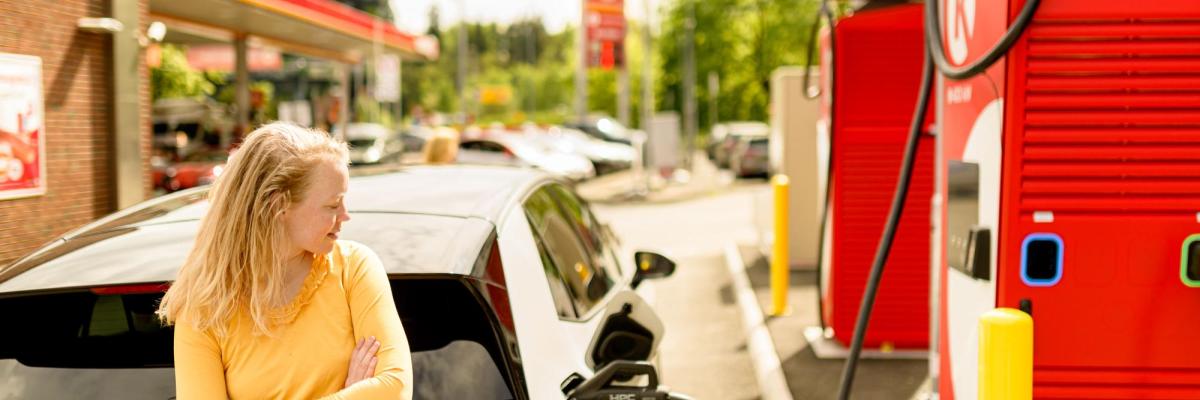 Woman using ev charger