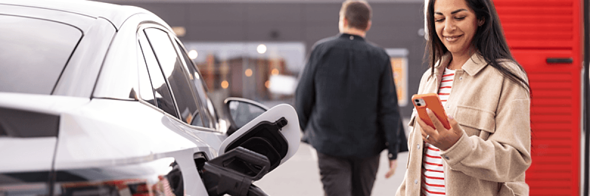Woman using ev charger