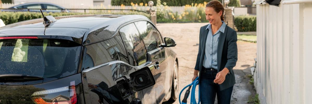 Woman using ev charger