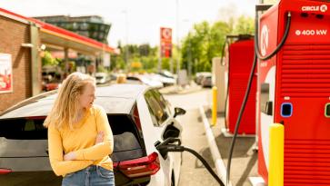 Woman using ev charger