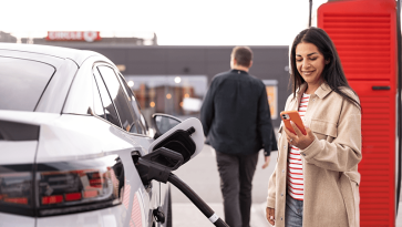 Woman using ev charger