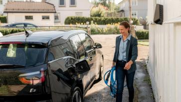 Woman using ev charger