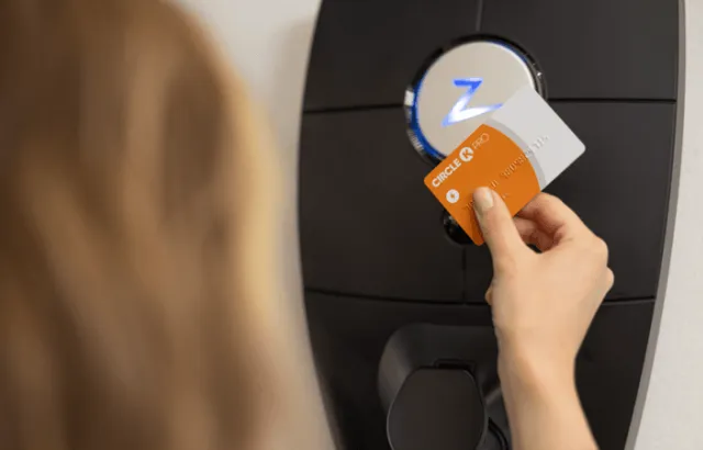 Woman using charging station at home