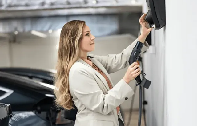 Woman using charging station at home